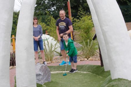 Family playing Adventure Golf
