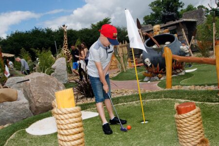 Family playing Adventure Golf