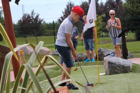 Family playing Adventure Golf