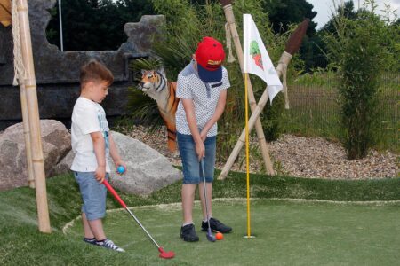Family playing Adventure Golf
