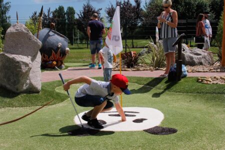 Family playing Adventure Golf